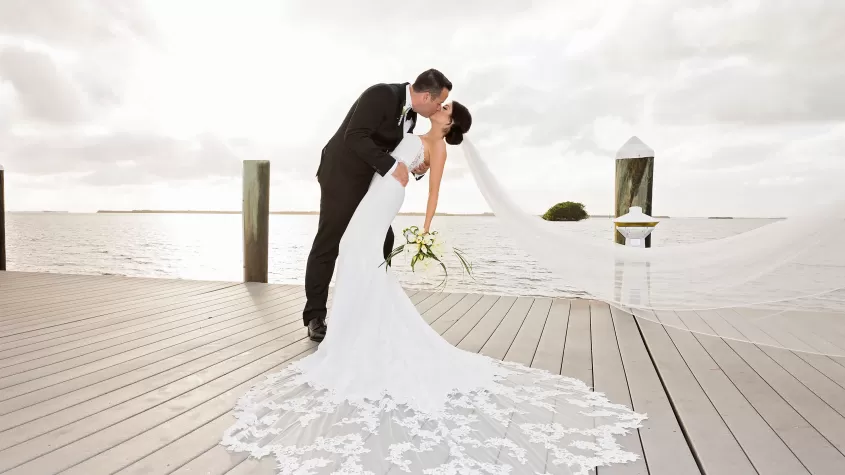 Wedding couple kissing on dock