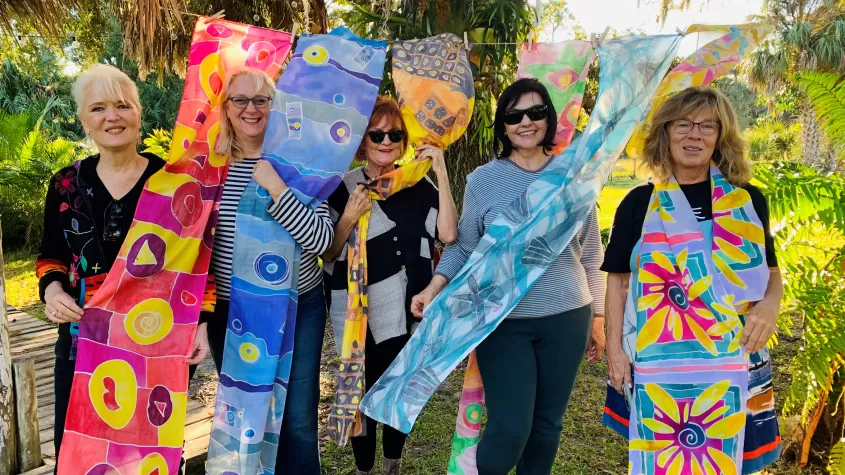 Participants paint beautiful scarves along the Caloosahatchee River. 